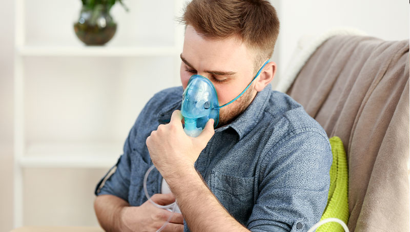 Man using nebulizer to control asthma