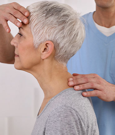 Chiropractor making adjustment to relieve migraine