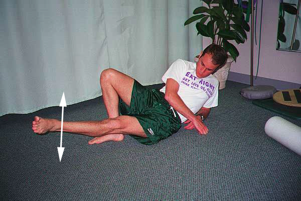 Dr. Ezgur performing Quad Setting with Leg Raise exersise